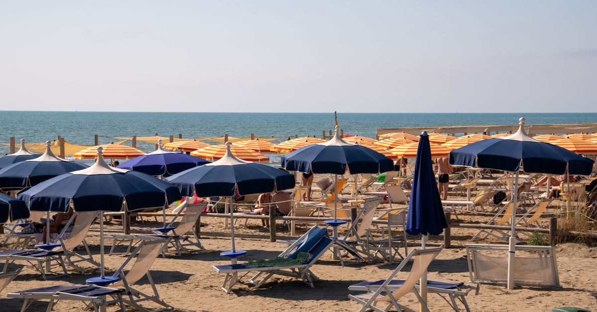 Colourful sun umbrellas and lounge chairs on a sunny summer beach