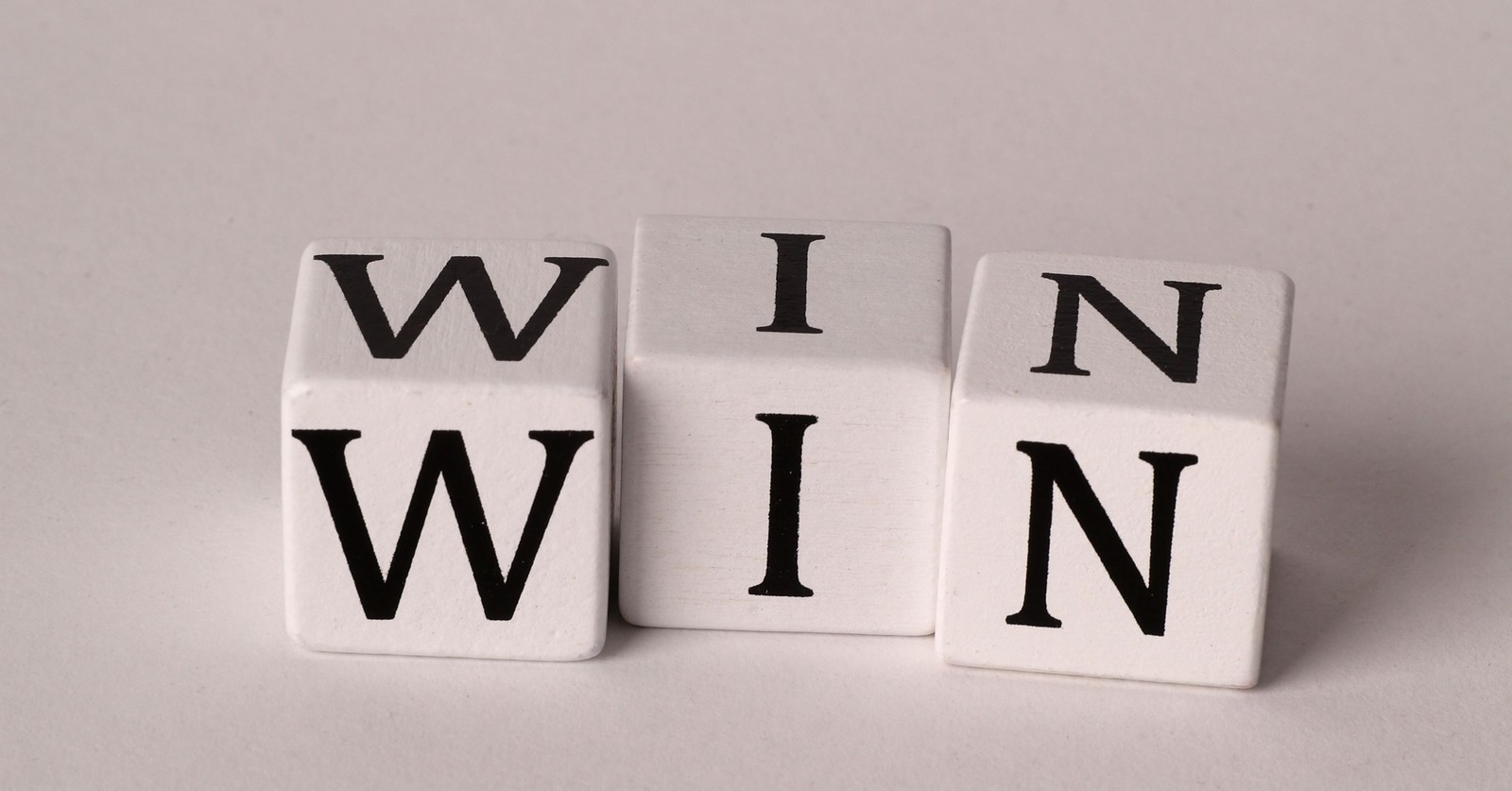 White blocks spelling WIN, symbolizing an employer-side win